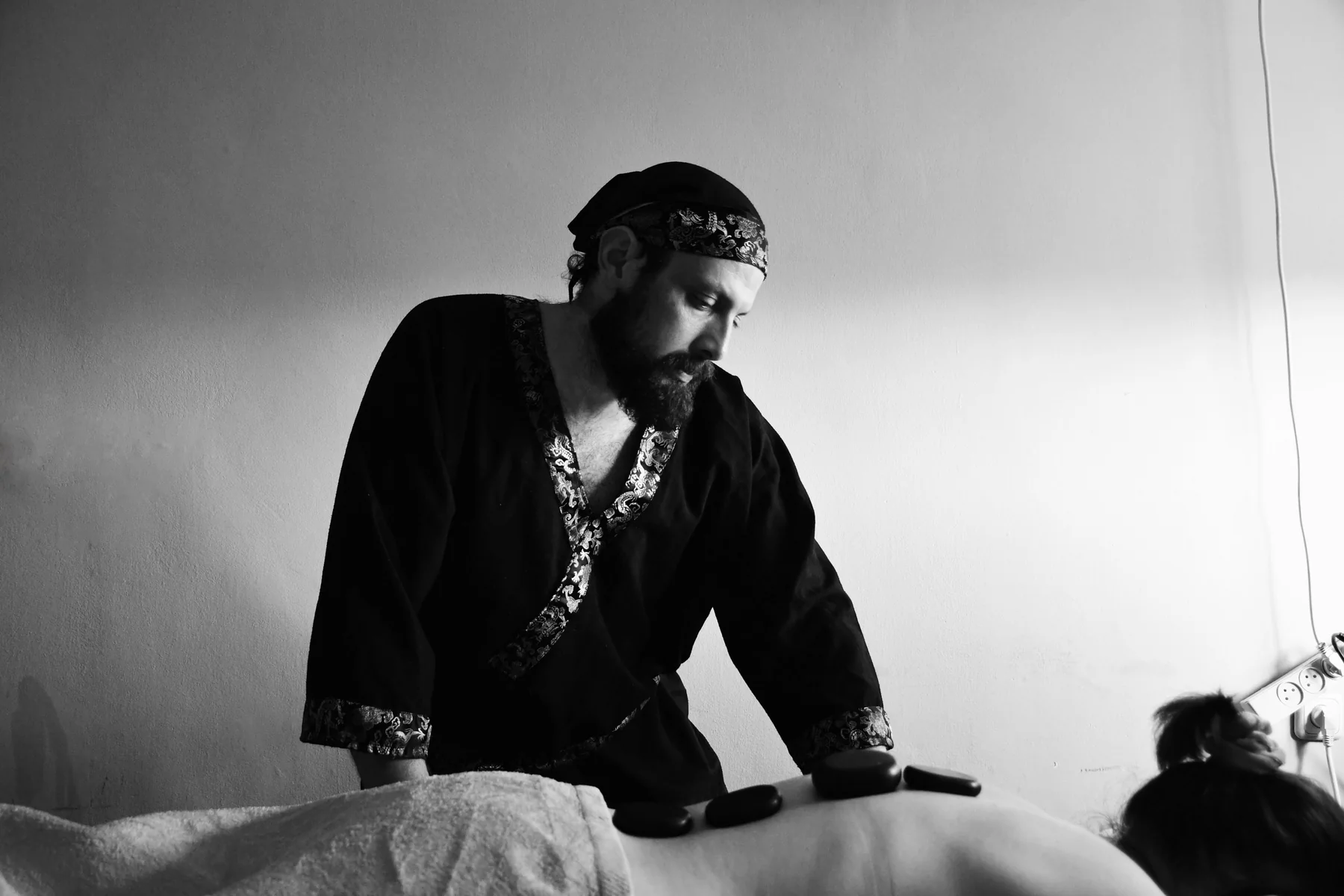 Professional hot stone massage in a calm spa setting